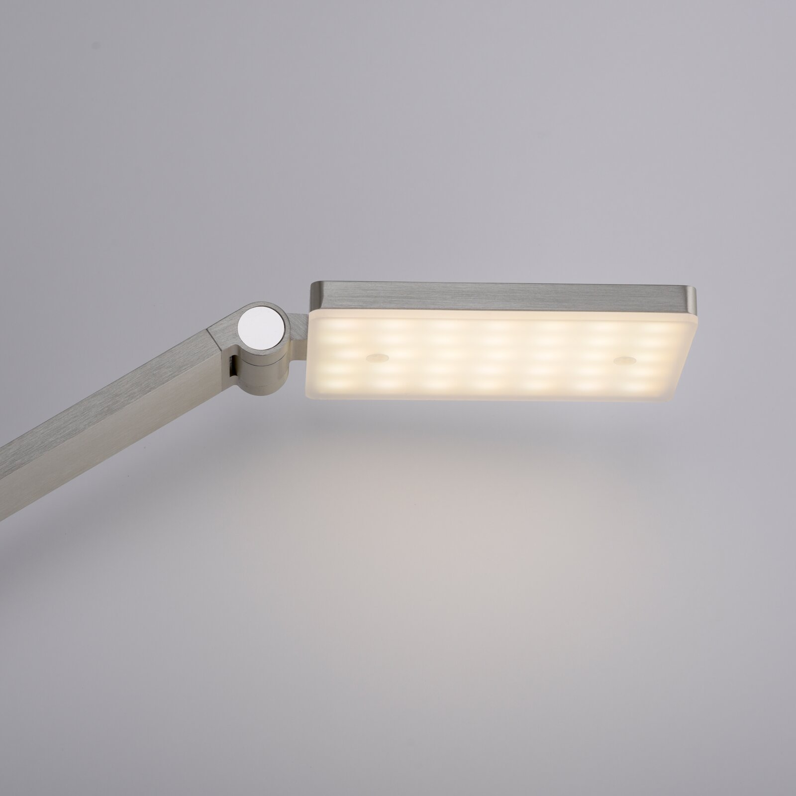 Moderne LED-Tischleuchte mit rechteckigem, leuchtendem Kopf in seitlicher Perspektive