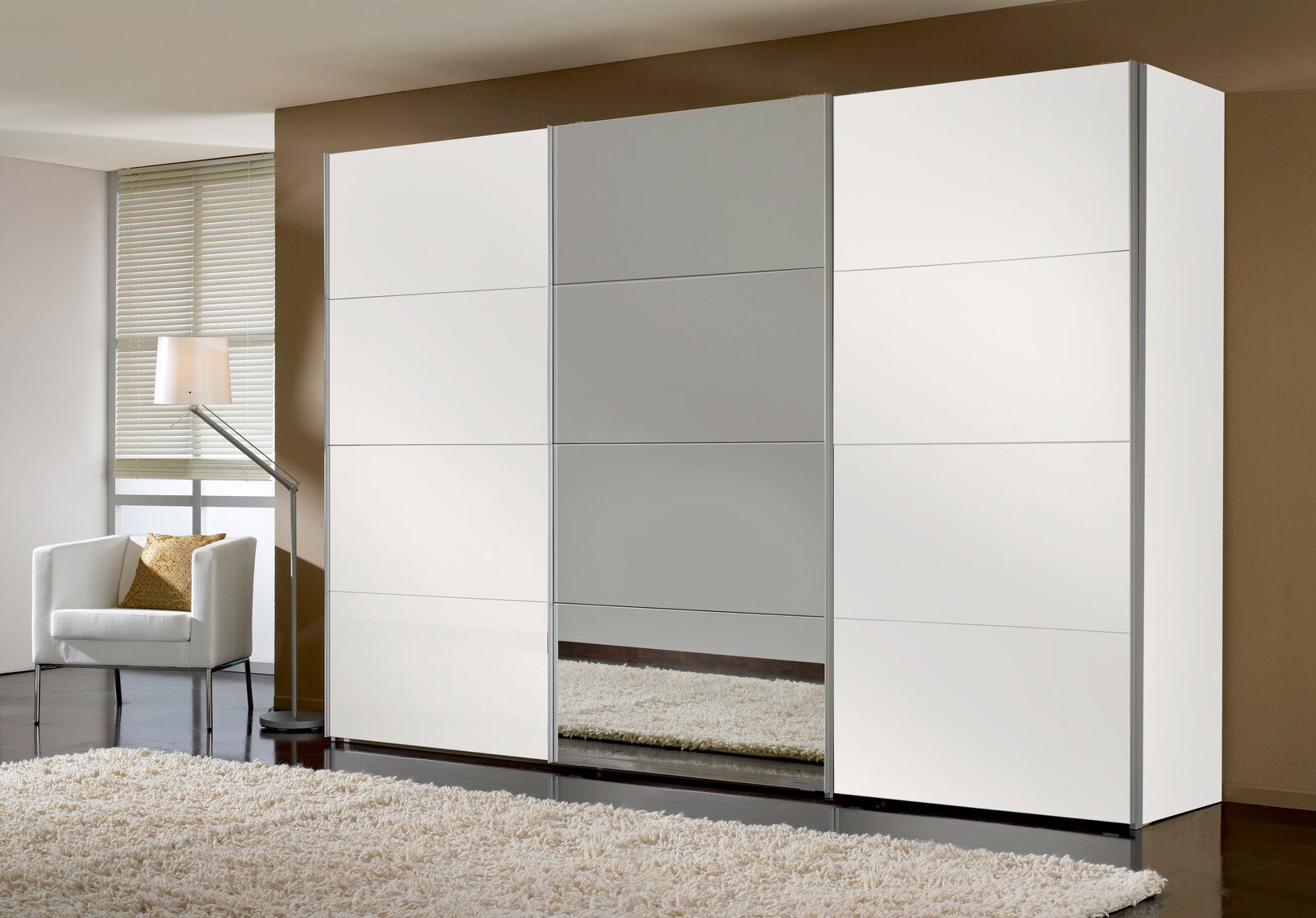 Moderner dreitüriger Schwebetürenschrank in Weiß mit Spiegel in der Mitte, seitliche Perspektive.