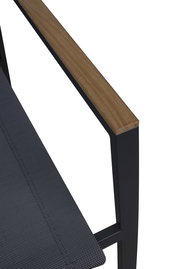 Nahaufnahme eines Stapelstuhls mit einem Armlehnen-Detail aus Holz und einem schwarzen Metallrahmen, seitliche Perspektive.