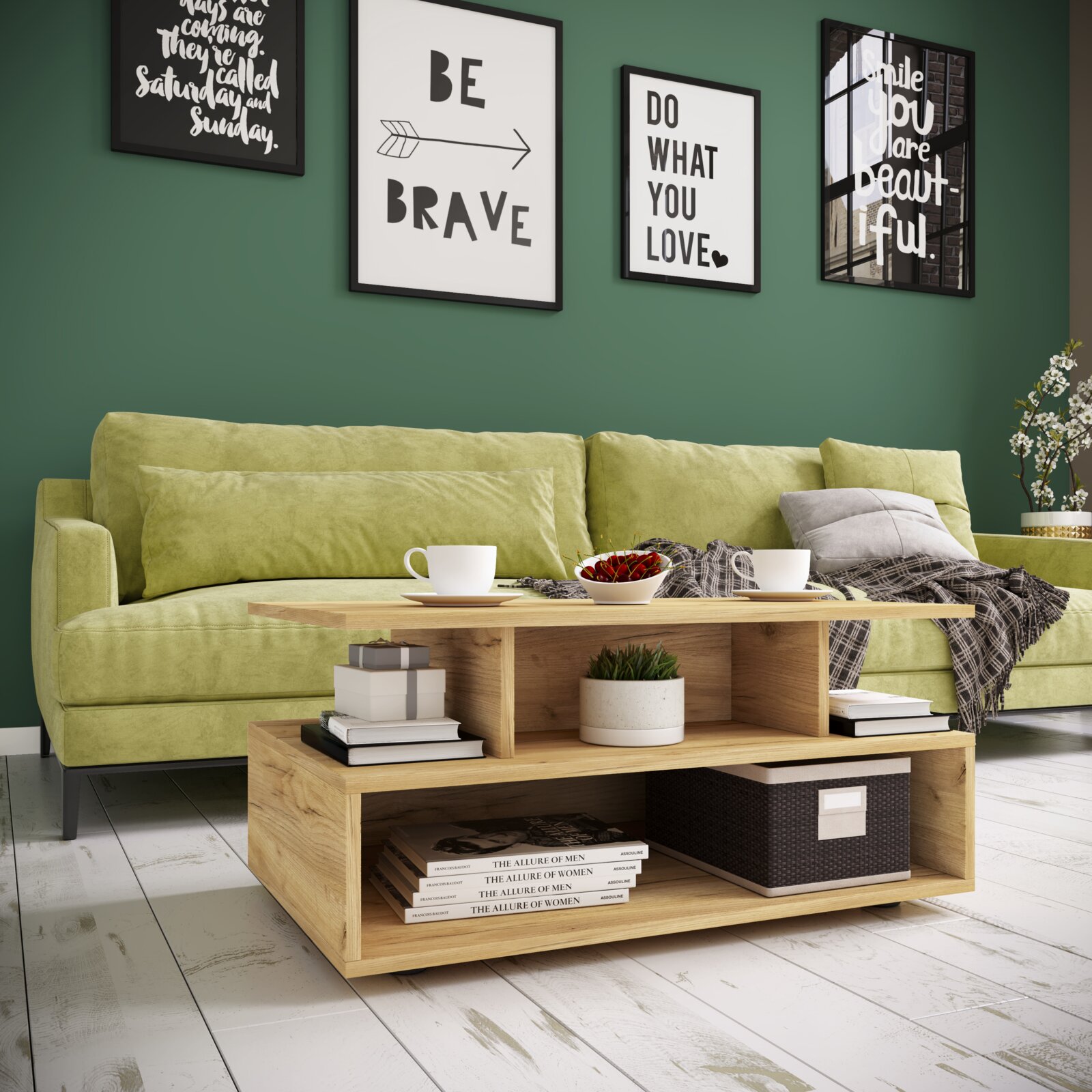 Moderner Couchtisch aus hellem Holz mit offenem Ablagefach vor einem grünen Sofa, darauf Tassen und Schale, im Hintergrund gerahmte Poster an grüner Wand Perspektive: leicht schräg von vorne auf Augenhöhe.