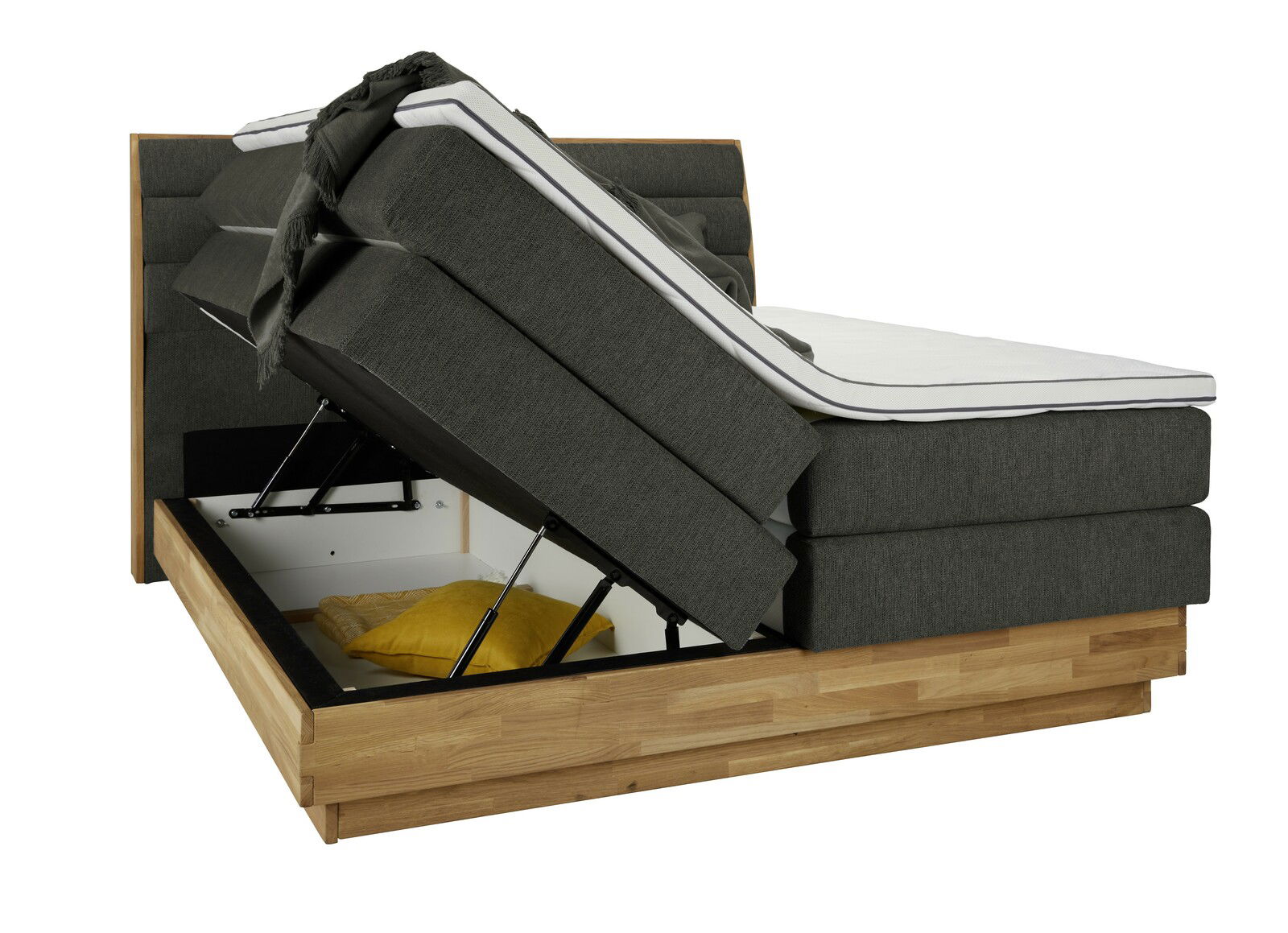 Boxspringbett mit hochgeklappter Matratze und Stauraum, seitliche Perspektive