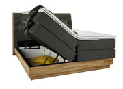 Boxspringbett mit hochgeklappter Matratze und Stauraum, seitliche Perspektive