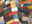 Patchwork-Lederteppich aus verschiedenen bunten Etiketten, perspektivisch von der Seite fotografiert.
