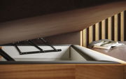 Nahaufnahme eines geöffneten Boxspringbetts mit Stauraum, seitliche Perspektive