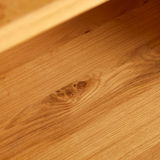 Nahaufnahme der Holzmaserung eines Regals aus der Perspektive von oben.