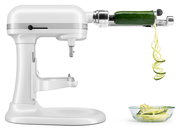 Weiße Küchenmaschine mit Spiralschneider-Aufsatz, der eine Zucchini in Spiralen schneidet, seitliche Perspektive.