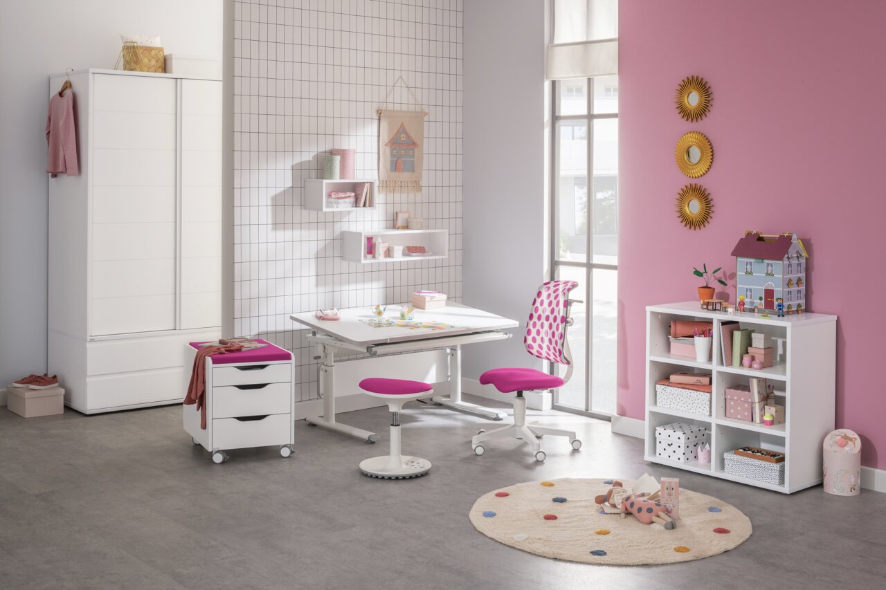 Paidi Jugenddrehstuhl SINO 2 Moderner Jugenddrehstuhl mit pinkem Sitz und gepunkteter Rückenlehne, seitliche Perspektive in einem stilvoll eingerichteten Kinderzimmer.