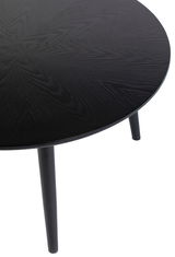 Runder schwarzer Esstisch mit Holzmaserung, Ansicht von oben.