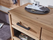 Nahaufnahme eines Schuhschranks aus Holz mit schwarzem Griff, darauf liegen ein Schlüsselbund, eine Kamera und Briefe.