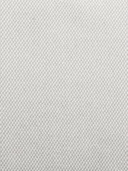 Nahaufnahme eines hellen, strukturierten Stoffes in beige Farbe, verwendet für einen Armlehnstuhl.