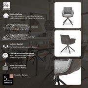 Grauer Armlehnstuhl mit schwarzem Eisengestell, Vorder- und Rückansicht, drehbar mit Rückholfunktion, in einem modernen Esszimmer.