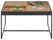 Moderner Couchtisch mit Holzplatte und schwarzem Metallgestell, frontal fotografiert. Auf der Tischplatte befinden sich ein Glas, Zeitschriften und Dekoration.