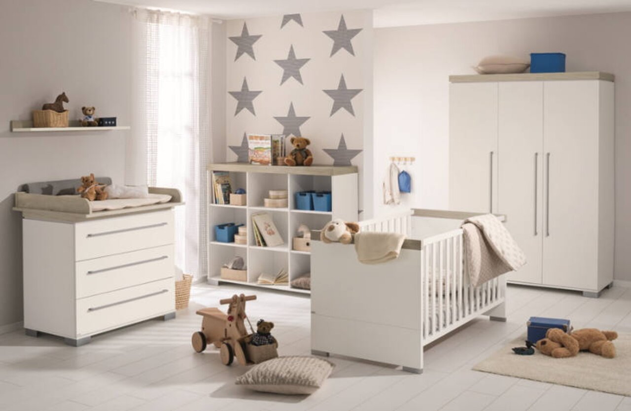 Kinderkamer met wandplank, commode, boekenkast en kinderbed in een moderne, lichte inrichting, zijaanzicht
