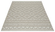Beiger Flachgewebe-Teppich mit geometrischem Rauten- und Bordürenmuster in Naturtönen, frontal von oben in leichter Perspektive fotografiert.