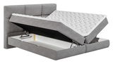 Graues Boxspringbett mit Stauraum, seitliche Perspektive
