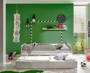 Jugendbett in einem sportlich dekorierten Zimmer mit grünem Hintergrund, Fußballthema und zusätzlichem Ausziehbett, seitliche Perspektive