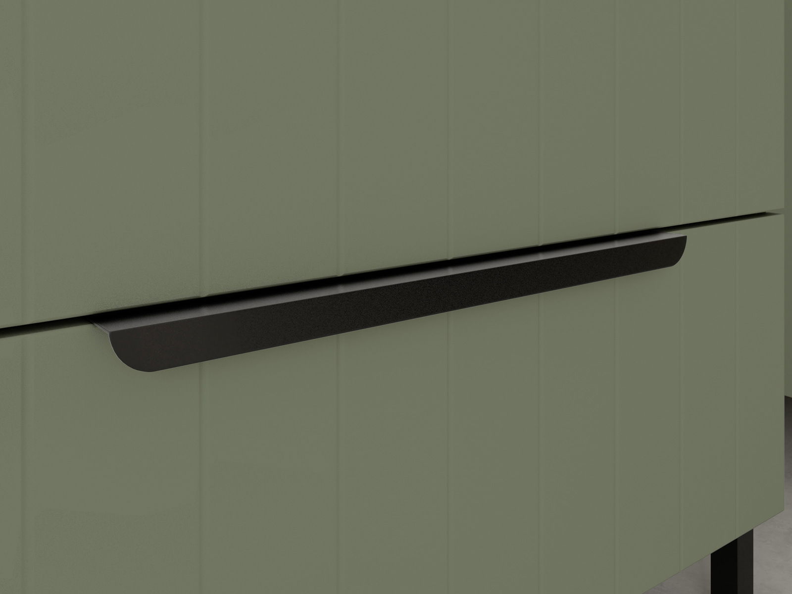 Nahaufnahme eines olivgrünen Waschbeckenunterschranks mit schwarzem Griff, seitliche Perspektive