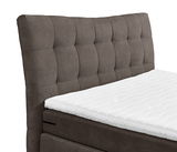 Boxspringbett mit gepolstertem Kopfteil in seitlicher Perspektive