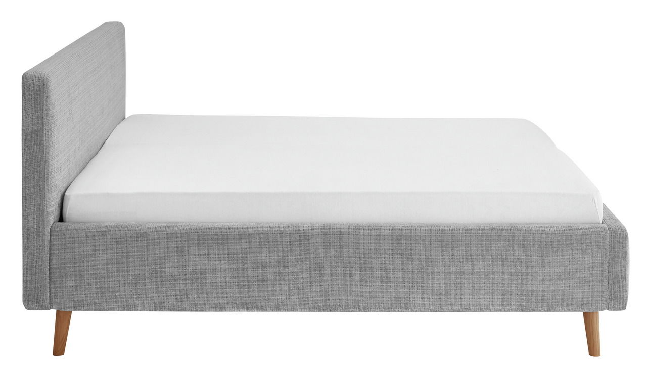 Seitliche Ansicht eines grauen Polsterbettgestells mit Holzfüßen und weißer Matratze.