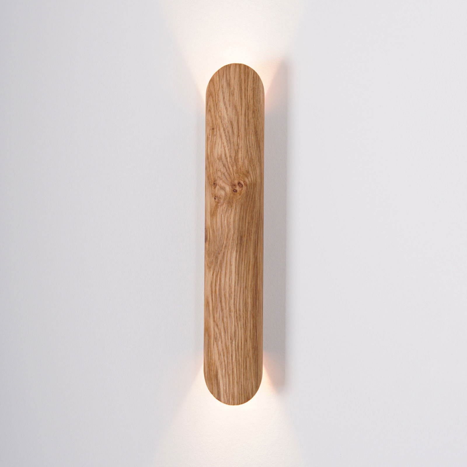LED-Wandleuchte aus Holz mit vertikaler Ausrichtung, warmes Licht strahlt nach oben und unten, frontale Ansicht.