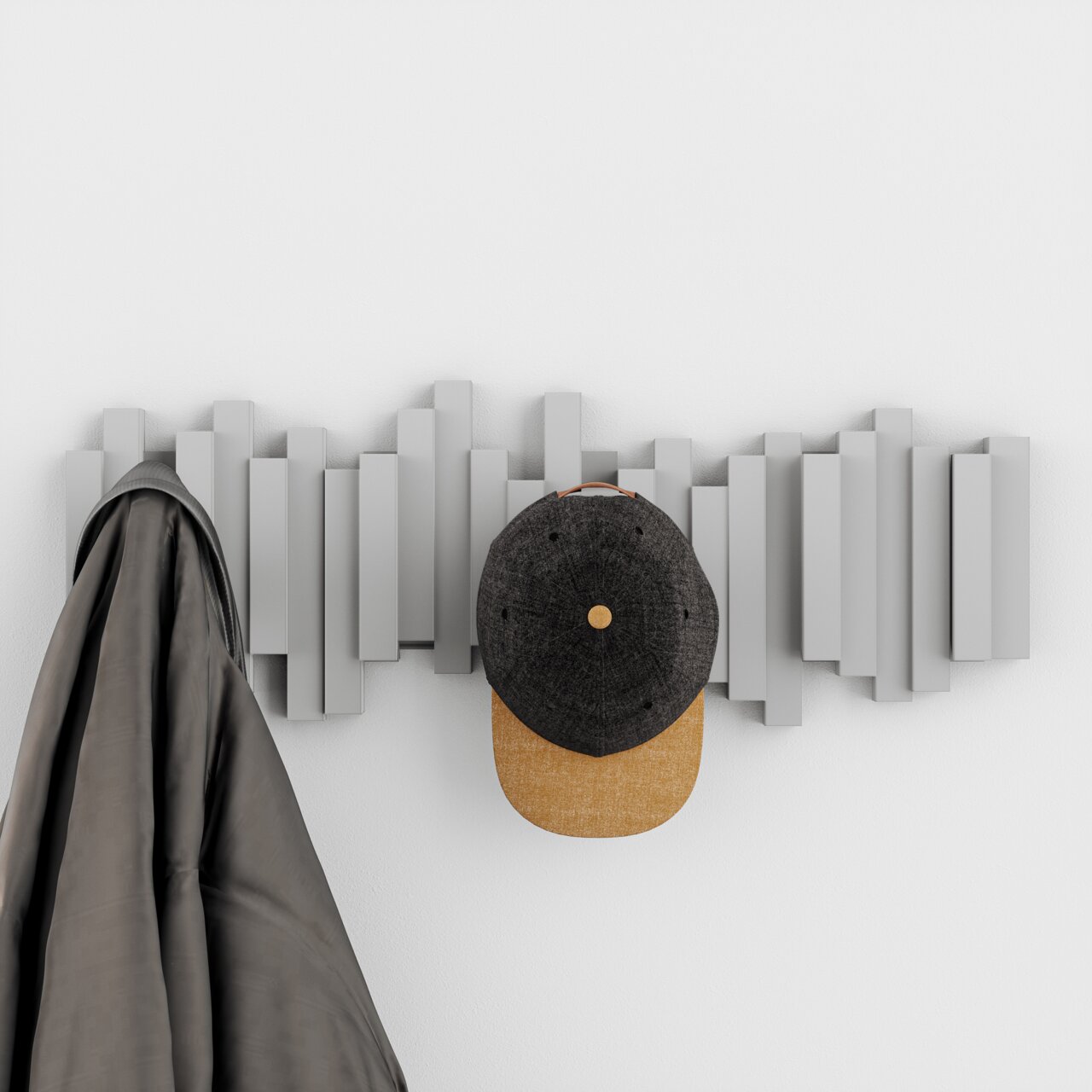 Moderne Wandgarderobe mit geometrischem Design, frontal betrachtet, mit einem Mantel und einer Kappe aufgehängt.
