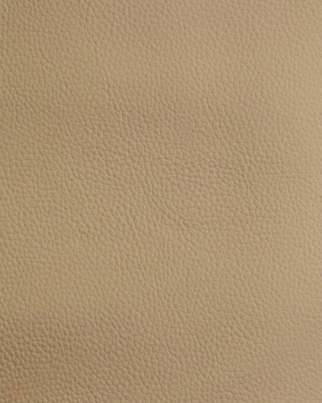 Nahaufnahme einer beige strukturierten Lederoberfläche, verwendet für einen Stuhl.