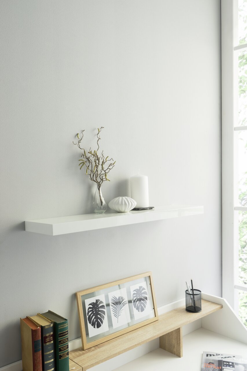 Weißes Wandboard mit Dekoration, seitliche Perspektive