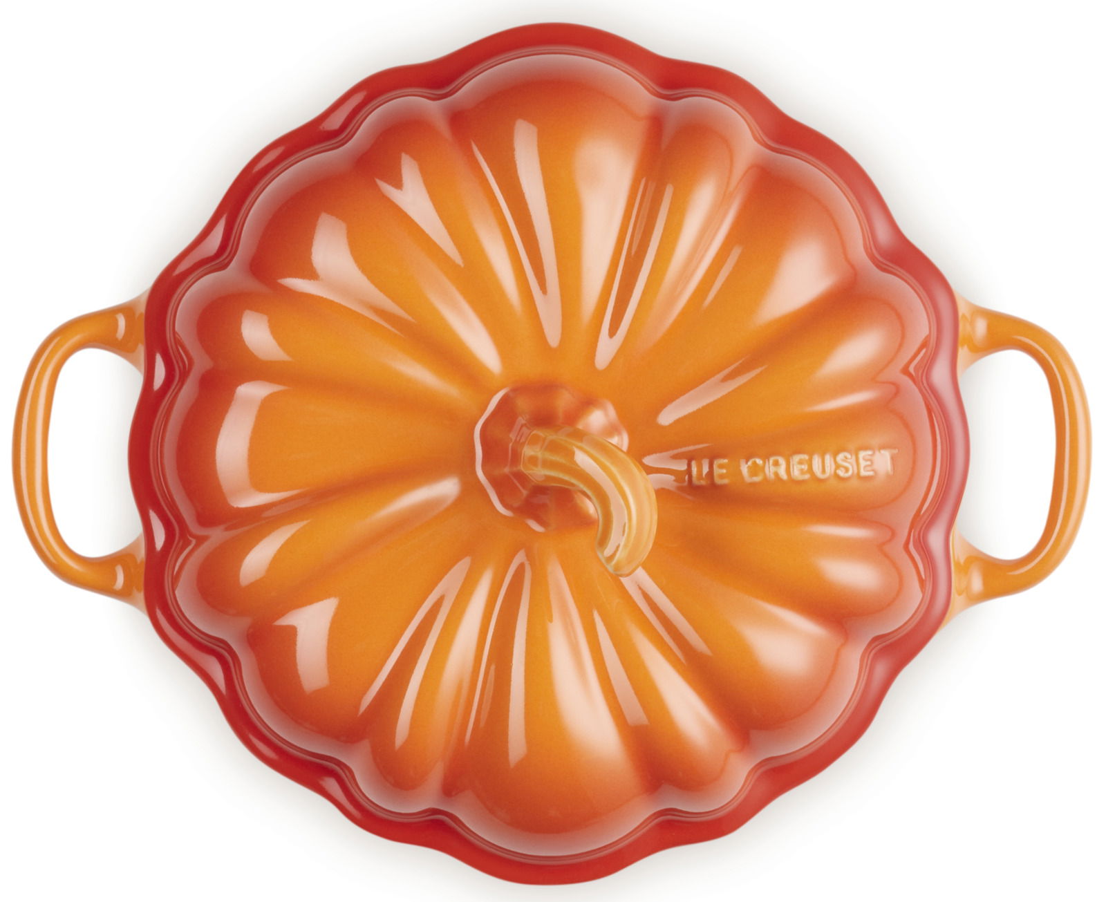 Ofenrote Kürbisförmige Auflaufform mit Deckel, von oben betrachtet, mit zwei Griffen und der Aufschrift 'Le Creuset'.