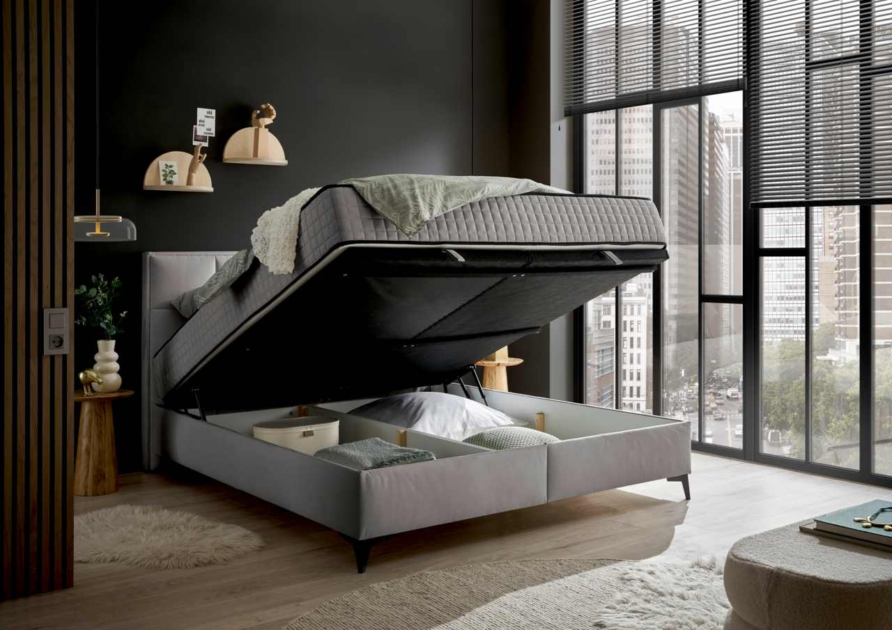 Boxbett mit hochgeklappter Matratze und Stauraum darunter, seitliche Perspektive