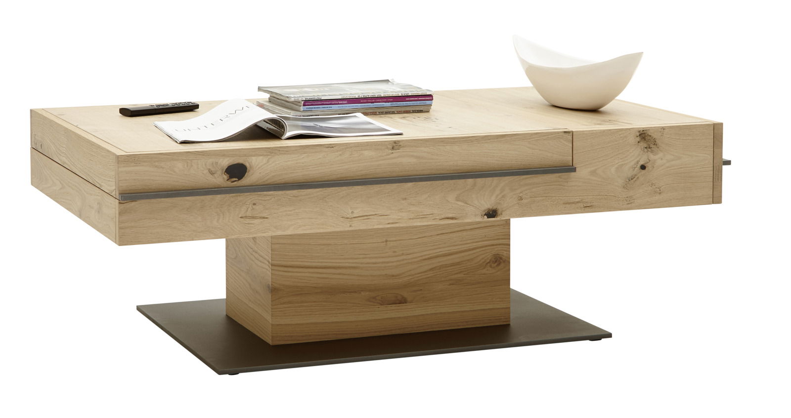 Moderner Couchtisch aus Holz mit rechteckiger Form, auf einer stabilen Basis stehend, von der Seite betrachtet. Auf der Tischplatte liegen Zeitschriften und eine Fernbedienung, daneben steht eine weiße Schale.