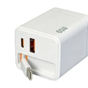 Weißes 65W-GaN-Schnellladegerät mit zwei USB-A-Ports und einem USB-C-Port, schräg von vorne links fotografiert; ein USB-C-Kabel ist eingesteckt.