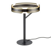 Moderne schwarze Tischleuchte mit rundem Standfuß und zylindrischem Stab, oben ein ringförmiger Schirm aus getöntem Glas mit warmweißem LED-Lichtring, Kabel sichtbar; Frontalansicht leicht von oben.