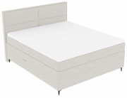 Boxspringbett in seitlicher Perspektive mit hellem Stoffbezug und schlichtem Design