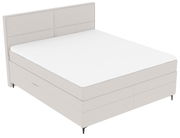 Boxspringbett in seitlicher Perspektive mit hellem Stoffbezug und schlichtem Design