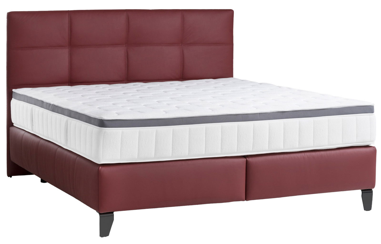 Boxspringbett mit rotem Kopfteil und weißer Matratze, seitliche Perspektive