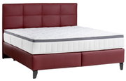 Boxspringbett mit rotem Kopfteil und weißer Matratze, seitliche Perspektive