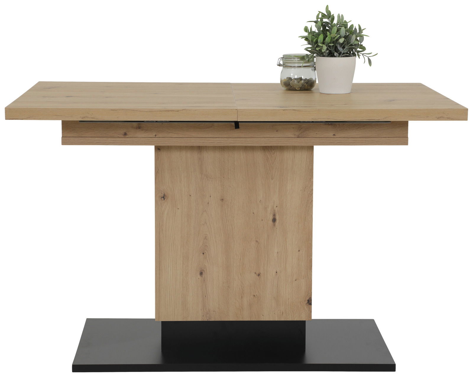 Moderner Esstisch aus Holz mit rechteckiger Tischplatte und zentralem Standfuß, dekoriert mit einer Pflanze und einem Glasgefäß, Frontalansicht.