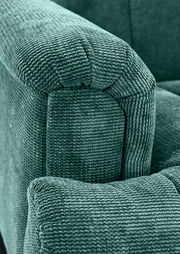 Nahaufnahme einer grünen, strukturierten Polsterung einer 2,5er-Sitzbank, seitliche Perspektive.