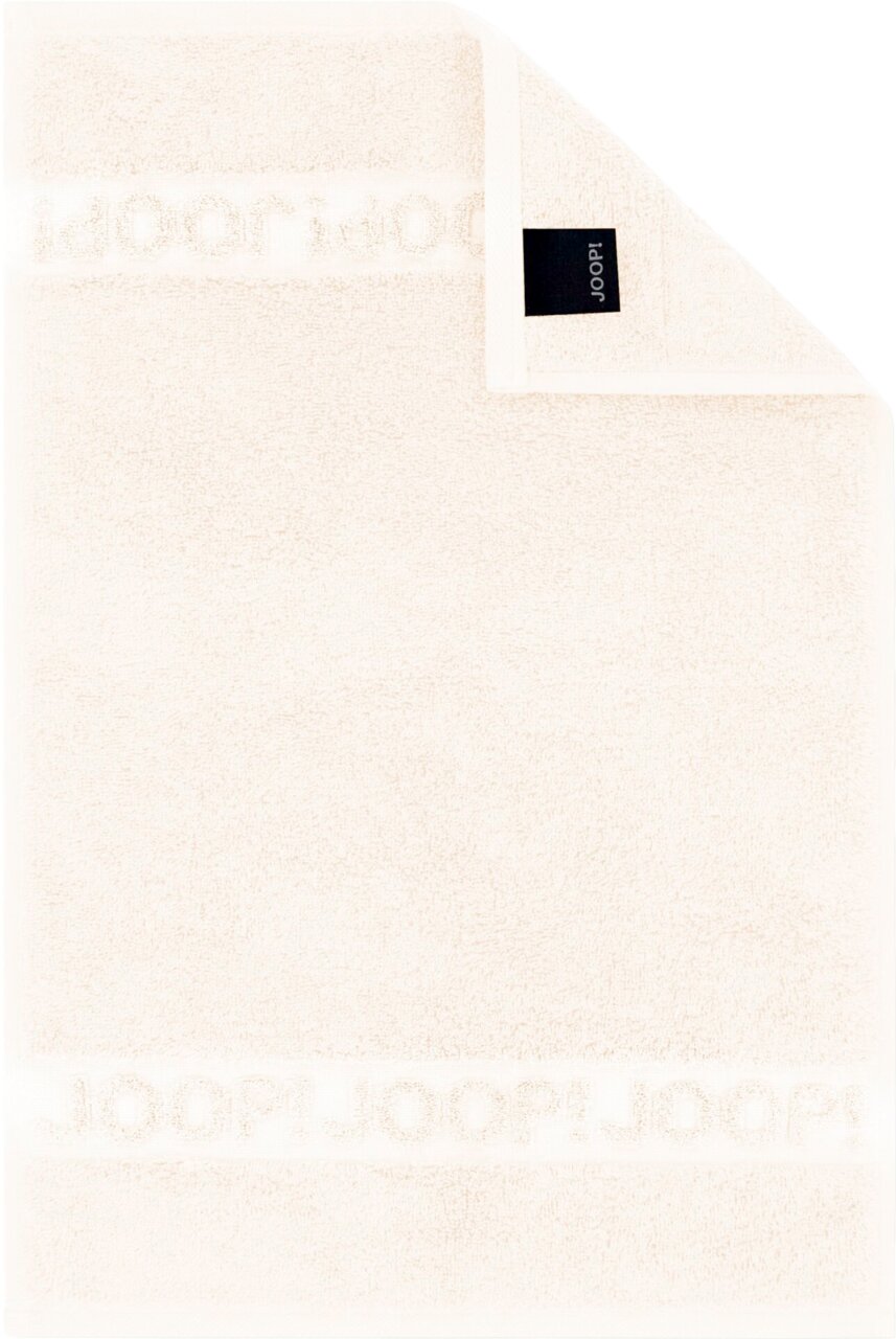 Cremefarbenes JOOP! Frottierhandtuch mit eingewebtem Logo-Bordürenstreifen und schwarzem Markenlabel, flach von oben fotografiert (Draufsicht)