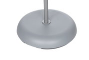 Close-up van de voet van een zilveren staande lamp, gezien vanuit vogelperspectief