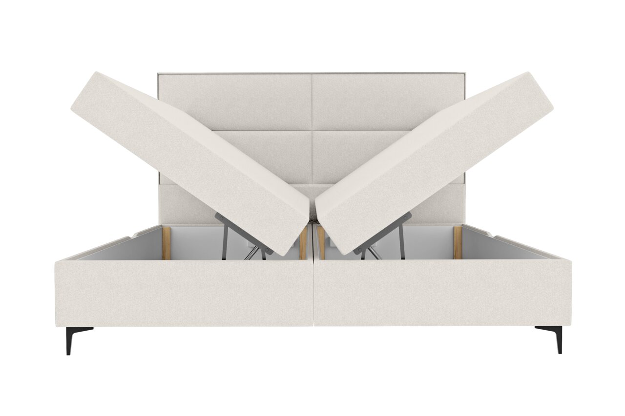 Frontale Ansicht eines Boxspringbetts mit hochgeklappten Matratzen, die den Stauraum darunter zeigen.