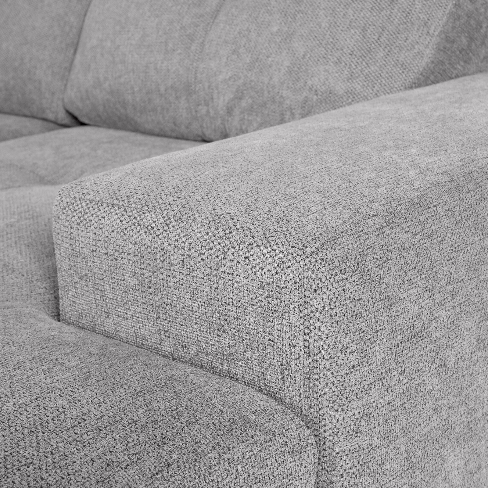 Nahaufnahme einer grauen Stoff-Rundecke mit Armlehne, seitliche Perspektive