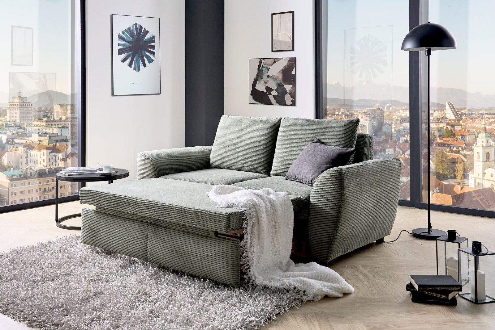 Funktionssofa in einem modernen Wohnzimmer mit Panoramablick, von vorne betrachtet.