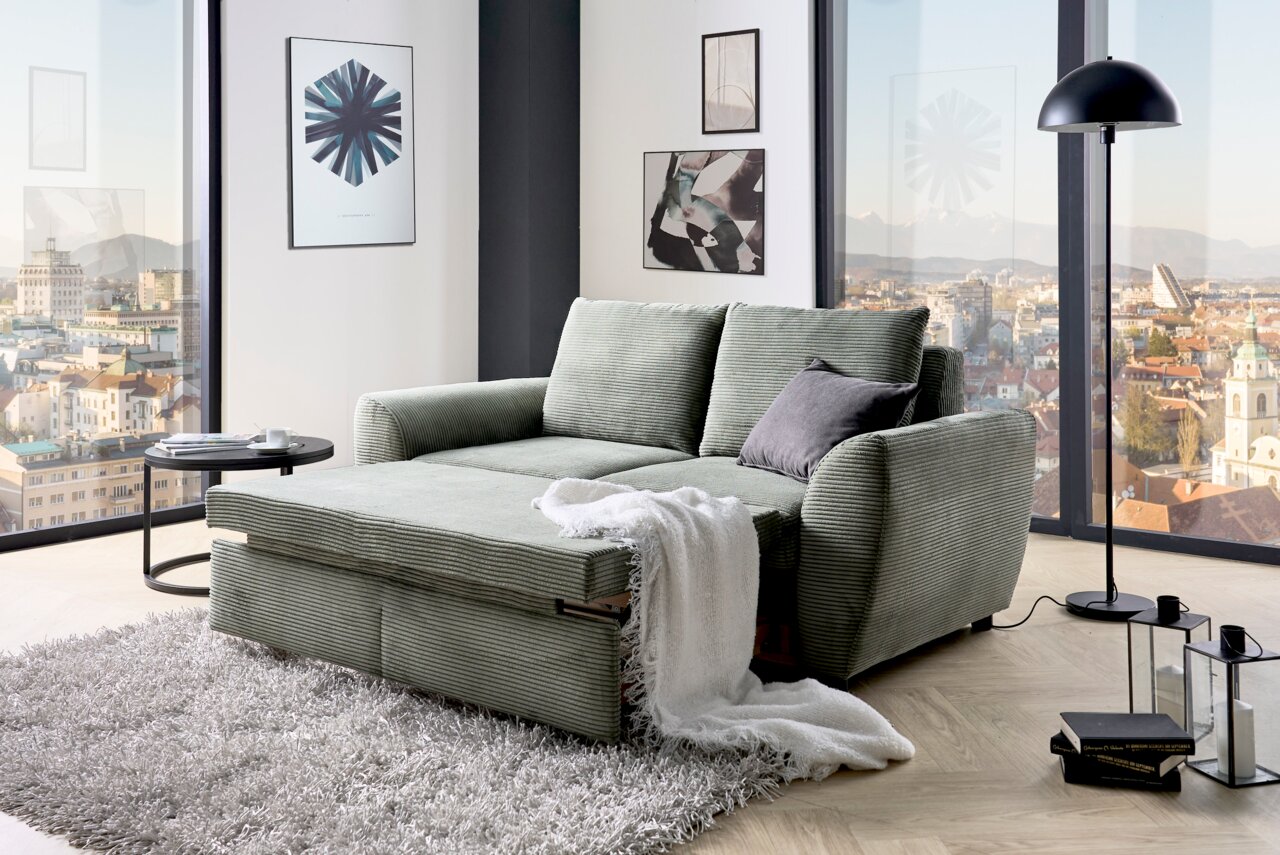 Funktionssofa in einem modernen Wohnzimmer mit Panoramablick, von vorne betrachtet.