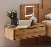 Holz-Nachtkonsole mit Schublade, dekoriert mit Pflanze, Büchern und Vase, seitliche Perspektive