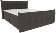 Donkergrijs, gestoffeerd boxspringbed met een met stof bekleed, geknoopt hoofd- en voeteneinde, schuin van linksvoor in driekwartperspectief op een witte achtergrond