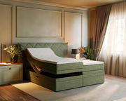Boxspringbett in einem stilvollen Schlafzimmer, seitliche Perspektive, mit verstellbarer Matratze und eleganter grüner Polsterung.