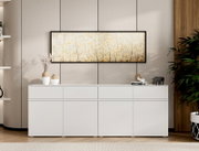 Frontalansicht eines horizontalen Wandbilds im schwarzen Rahmen mit zartem Blüten-/Gräsermotiv in Beige und Gold über einem weißen Sideboard in modernem Wohnraum.