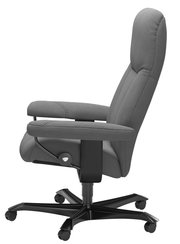 Grauer Chefsessel in Seitenansicht mit gepolsterten Armlehnen und fünf Rollen.