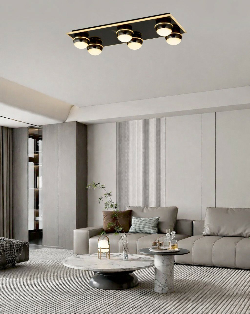 Moderne LED-Deckenleuchte mit sechs runden Leuchtkörpern in einem stilvollen Wohnzimmer, Perspektive von unten.